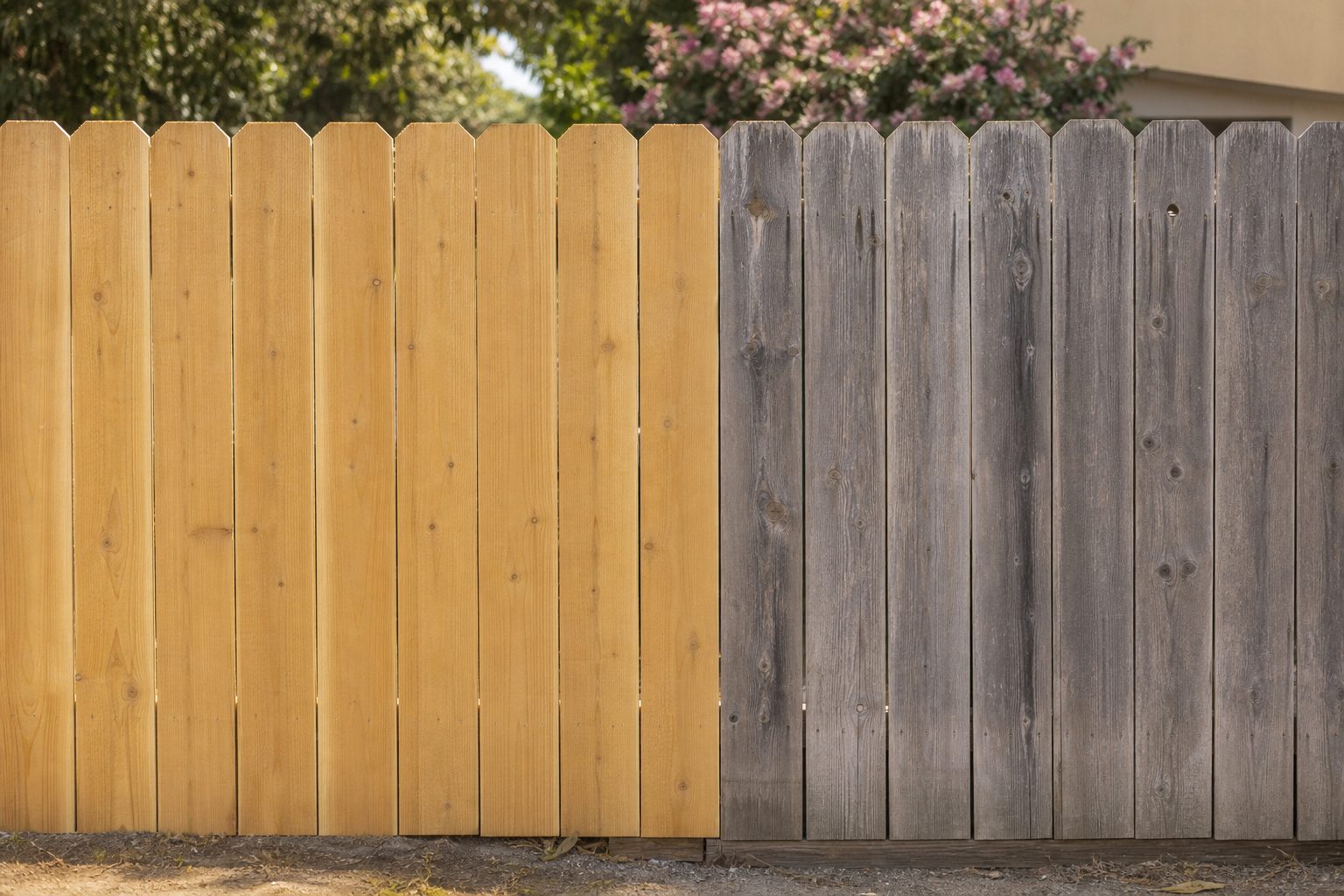 New fence boards beside older weathered boards showing the colour mismatch after a fence repair